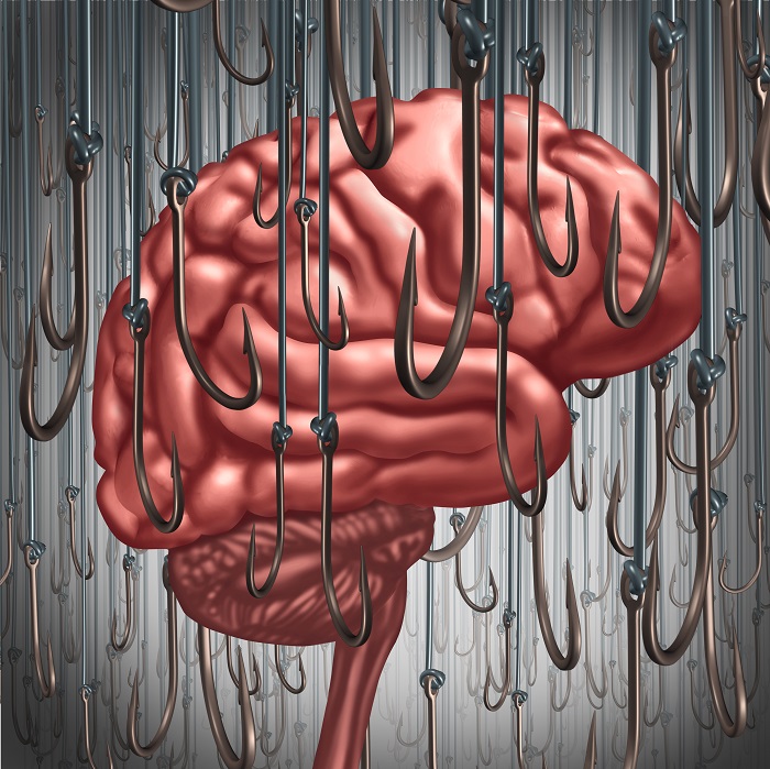 Addiction and dependency concept as a human brain being lured and surrounded by fishing hooks as a risk symbol and metaphor for a drug addict or the danger of alcoholism gambling and drug abuse smoking as a mental health problem.